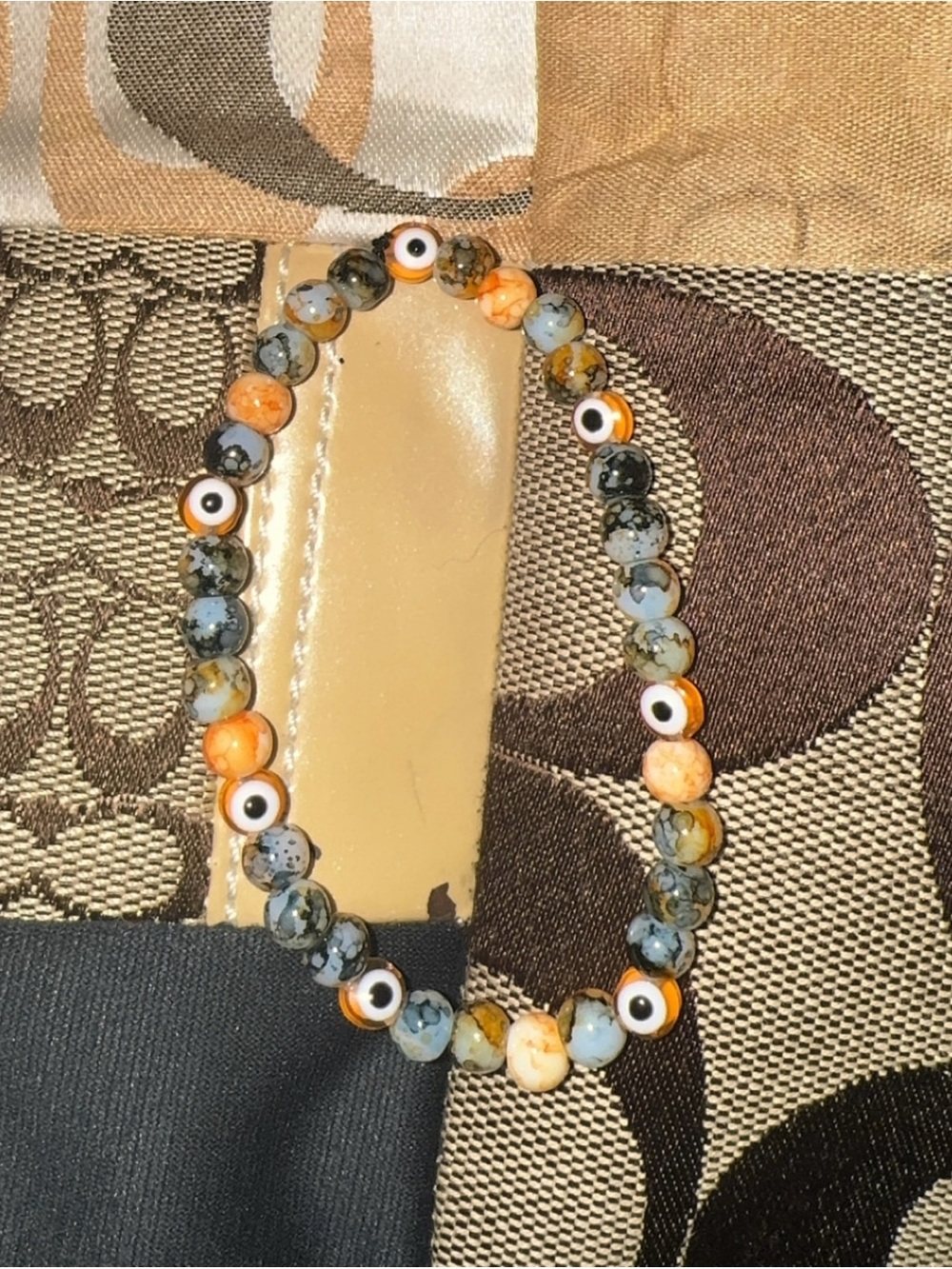 Orange Evil Eye Protection beaded stretch bracelet insta- @braceletique_333